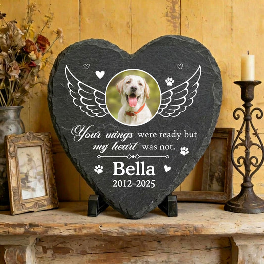Heart personalized pet memorial stone with custom dog photo and angel wings illustration on textured natural slate.