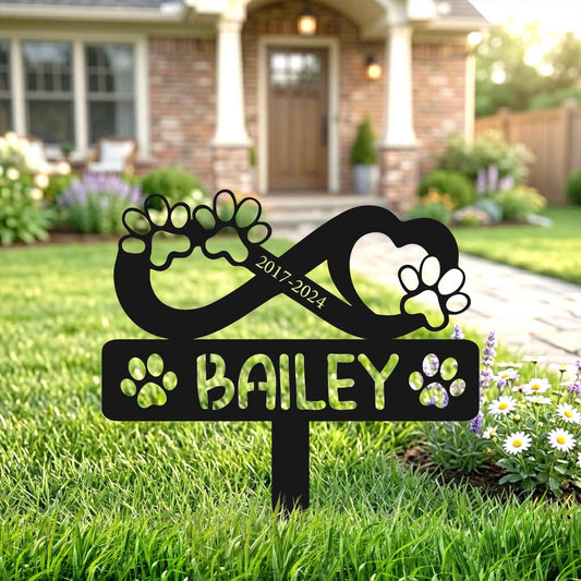 Decorative winged dog garden plaque near flower bushes