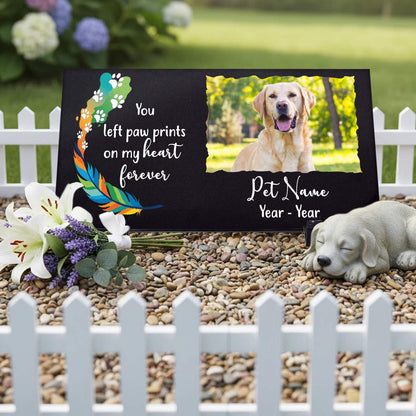 Black granite pet memorial plaque placed on garden turf